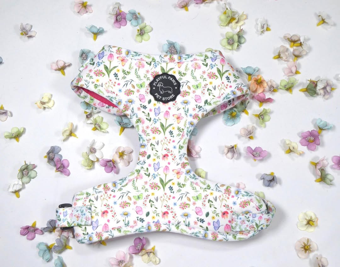 Playful Paws floral print adjustable dog harness laid out with spring flowers